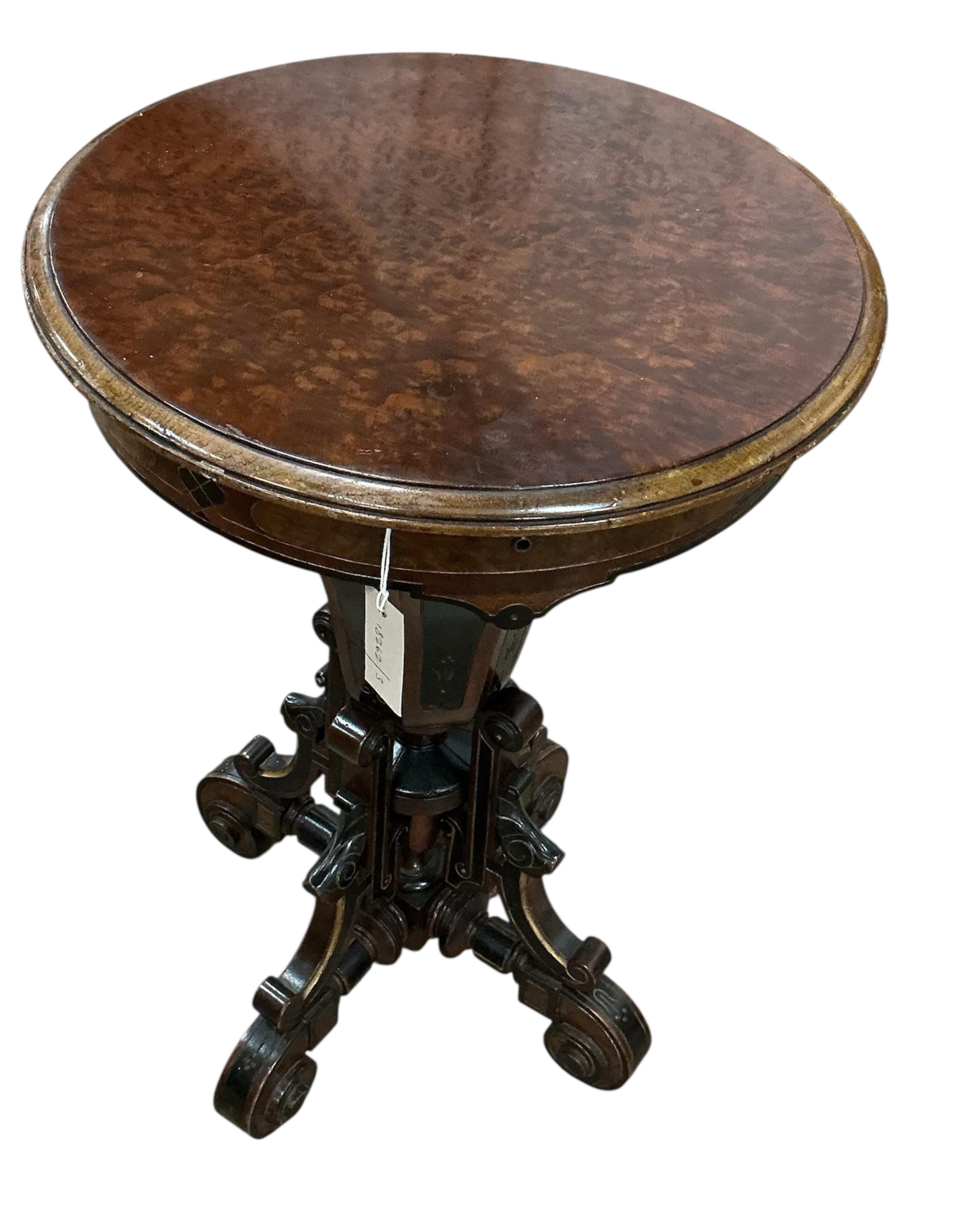 A Victorian circular ebonised amboyna work table, diameter 49cm, height 72cm